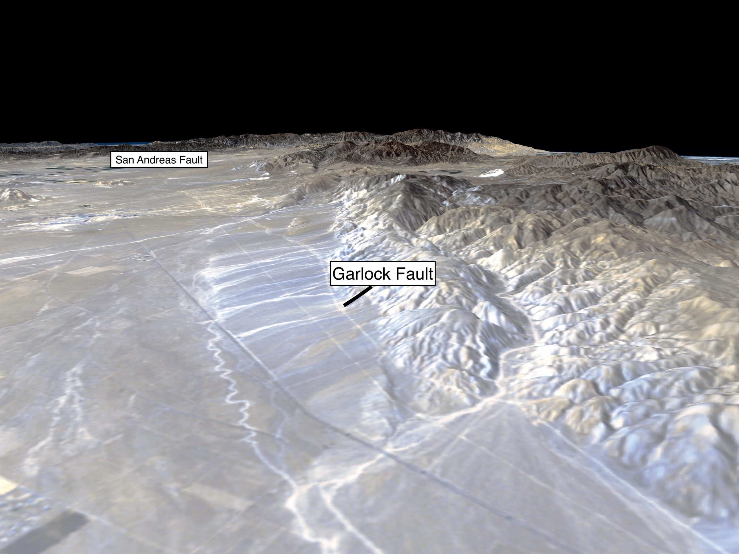 The Garlock fault runs along the foot of the Sierra Nevada Mountains at the northern edge of the Mojave Desert. In this picture the Garlock fault meets with the San Andreas Fault at the base of the San Gabriel Mountains in the distance on the left. Credit: NASA/JPL/NIMA